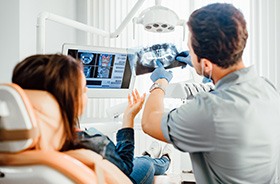 Dentist and patient reviewing X-ray together
