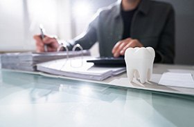 Man sitting at desk, budgeting for dental care