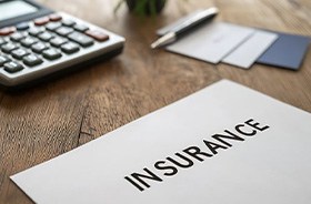 Insurance document next to calculator