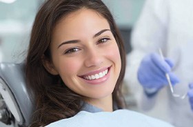Smiling patient in dental treatment chair