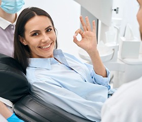 Happy dental patient making OK sign