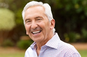 Happy senior man enjoying the benefits of All-on-4 dental implants