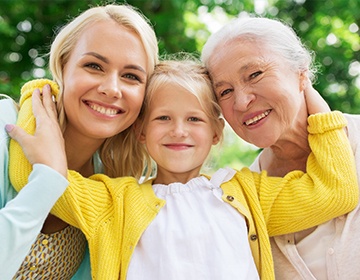 Smiling family of three outdoors