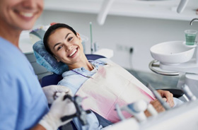 Happy patient with dental team member