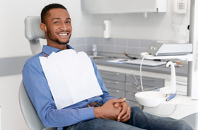 Male patient relaxing in dental treatment chair