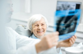 Dentist and patient discussing need for tooth-colored filling