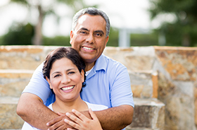 Older man and woman smiling outdoors