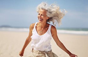 Happy senior woman enjoying time on the beach