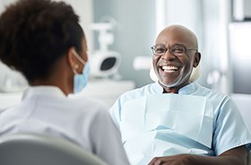 Happy senior dental patient interacting with dentist