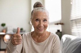 Happy senior woman, glad she could afford dentures