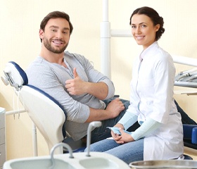 Female patient smiling after successful dental implant salvage treatment