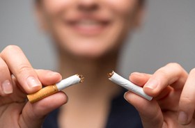 Woman quitting smoking to protect her dental implants
