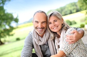 Happy senior couple with implant dentures in Woodbridge