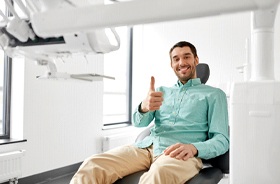 Man giving thumbs up after implant placement surgery