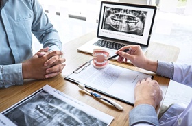 Dentist and patient having a conversation about dental implants