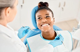 Happy patient smiling up at her dentist
