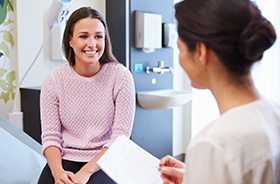 Woman talking to dentist