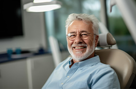 Smiling senior dental patient in treatment chair