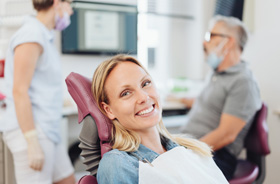 Smiling dental patient in treatment chair