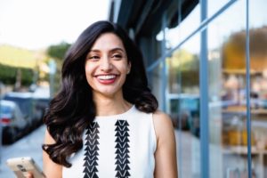 Smiling woman happy she took advantage of Invisalign promotion