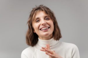 Smiling woman with braces as an adult in Woodbridge