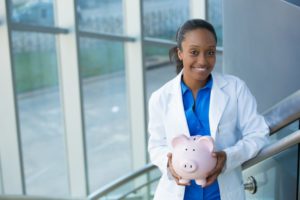 Dentist with piggy bank accepts dental insurance in Woodbridge