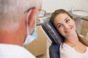Smiling patient conversing with her dentist