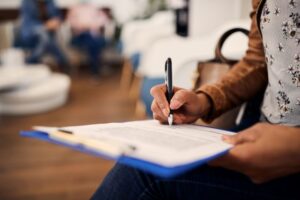 Patient filling out insurance document in dental office