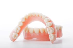 Dentures pictured against neutral background