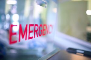Red “emergency” lettering on glass partition
