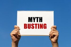 Two hands holding sign that says, &ldquo;Myth busting&rdquo; 