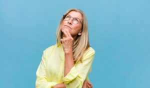 Middle-aged woman wearing curious expression 