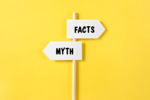 Signs pointing in opposite directions for myths and facts 